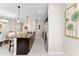 Modern kitchen with granite countertops, dark cabinets, and stainless steel appliances and marble tile flooring at 1596 Moon Valley Dr, Davenport, FL 33896