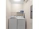 Practical laundry room with modern appliances, storage shelving, and functional layout for easy chore management at 1596 Moon Valley Dr, Davenport, FL 33896
