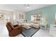 Comfortable living room with a white L-shaped sofa, a brown recliner, and stylish decor at 1596 Moon Valley Dr, Davenport, FL 33896
