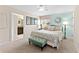 Comfortable main bedroom with neutral carpet, stylish decor, and an ensuite bathroom entrance at 1596 Moon Valley Dr, Davenport, FL 33896