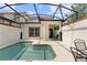 Enclosed backyard pool area with an outdoor seating space for relaxation and entertaining at 1596 Moon Valley Dr, Davenport, FL 33896