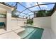 Private screened-in pool with patio seating, perfect for relaxation and entertainment at 1596 Moon Valley Dr, Davenport, FL 33896