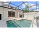 A private screened-in pool area with a seating area, creating a relaxing outdoor space at 1596 Moon Valley Dr, Davenport, FL 33896