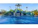 A colorful splash pad with interactive water features and safe, non-slip surfaces for community enjoyment at 1596 Moon Valley Dr, Davenport, FL 33896