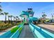 Exciting water slides in a community water park with palm trees, landscaping, and recreational fun at 1596 Moon Valley Dr, Davenport, FL 33896