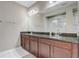 Bathroom featuring double sinks, granite counters, and a marble tile shower at 17084 Harbor Oak Pkwy, Winter Garden, FL 34787