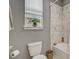 Bathroom with a white tiled shower, a window with blinds, and grey walls at 17084 Harbor Oak Pkwy, Winter Garden, FL 34787