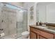 Bathroom featuring glass shower with marble-look tiling, wood vanity with granite counters, and modern fixtures at 17084 Harbor Oak Pkwy, Winter Garden, FL 34787