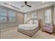 Primary bedroom with trey ceiling, neutral walls, windows with blinds, and elegant furnishings at 17084 Harbor Oak Pkwy, Winter Garden, FL 34787