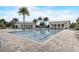 Beautiful community pool featuring palm trees and comfortable lounge chairs on a sunny day at 17084 Harbor Oak Pkwy, Winter Garden, FL 34787
