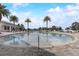 Large community pool with palm trees and lounge chairs, perfect for relaxation and recreation at 17084 Harbor Oak Pkwy, Winter Garden, FL 34787