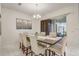 Elegant dining room with a large table, modern lighting, and access to the outdoor space at 17084 Harbor Oak Pkwy, Winter Garden, FL 34787