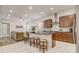 Open-concept kitchen featuring an island with seating and seamless flow to the living area at 17084 Harbor Oak Pkwy, Winter Garden, FL 34787