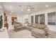 Spacious living room open to kitchen, featuring large sectional sofa, area rug, and sliding glass doors to the lanai at 17084 Harbor Oak Pkwy, Winter Garden, FL 34787