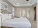 Comfortable main bedroom featuring a tray ceiling, neutral decor, and an ensuite bathroom at 17084 Harbor Oak Pkwy, Winter Garden, FL 34787