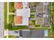 A bird's eye view showcases rooftops, driveways, green spaces, and a private pool in the backyard at 1745 Indiana Ave # J, Winter Park, FL 32789
