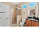 Cozy bathroom featuring a glass-enclosed shower and a vanity with a granite countertop at 1745 Indiana Ave # J, Winter Park, FL 32789