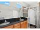 Bathroom features a large vanity with dual sinks, granite countertop, and a glass enclosed shower at 1745 Indiana Ave # J, Winter Park, FL 32789