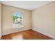 Bright bedroom with hardwood floors and a window offering neighborhood views at 1745 Indiana Ave # J, Winter Park, FL 32789