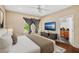 Comfortable bedroom with a ceiling fan, window with natural light, and a modern TV console at 1745 Indiana Ave # J, Winter Park, FL 32789