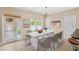 Sunlit dining room with modern table and chairs, hardwood floors, and access to the outdoors at 1745 Indiana Ave # J, Winter Park, FL 32789