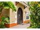 Close-up of the arched, double-door entry with stylish exterior lighting and landscaping at 1745 Indiana Ave # J, Winter Park, FL 32789