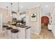 Open concept kitchen with modern pendants, stainless steel appliances, and counter seating at 1745 Indiana Ave # J, Winter Park, FL 32789