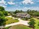 Expansive property featuring a beautiful home with a circular driveway, lush landscaping and mature trees at 17631 Vista Belle Ct, Montverde, FL 34756