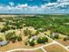 Stunning aerial view of an estate surrounded by mature trees and lush greenery at 17631 Vista Belle Ct, Montverde, FL 34756