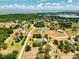 Aerial view of a home with a lake view, nestled among lush green trees in a serene and private community at 17631 Vista Belle Ct, Montverde, FL 34756