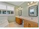 Bathroom with double vanity, mirrors and natural light at 17631 Vista Belle Ct, Montverde, FL 34756