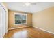 Bedroom featuring hardwood floors, window, ceiling fan, and closet with sliding doors at 17631 Vista Belle Ct, Montverde, FL 34756