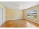 Bedroom featuring hardwood floors, a window, and a closet with sliding doors at 17631 Vista Belle Ct, Montverde, FL 34756
