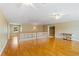 Bright bonus room with hardwood floors, white staircase railing, and neutral walls at 17631 Vista Belle Ct, Montverde, FL 34756