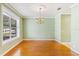 Formal dining room with chandelier, large window and neutral wall paint, perfect for entertaining at 17631 Vista Belle Ct, Montverde, FL 34756