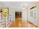 Bright foyer featuring hardwood floors, staircase, and access to a home office at 17631 Vista Belle Ct, Montverde, FL 34756