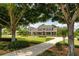 Inviting home featuring a circular driveway and manicured lawn, framed by mature trees at 17631 Vista Belle Ct, Montverde, FL 34756