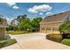 Three-car garage with driveway and lush lawn at 17631 Vista Belle Ct, Montverde, FL 34756