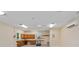 Bright garage featuring a workbench area with built-in cabinets and a convenient wall-mounted air conditioning unit at 17631 Vista Belle Ct, Montverde, FL 34756