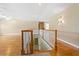 Upstairs hallway with hardwood flooring and staircase at 17631 Vista Belle Ct, Montverde, FL 34756