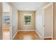 Hallway features hardwood floors, natural light, and access to multiple rooms at 17631 Vista Belle Ct, Montverde, FL 34756