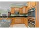 Modern kitchen with stainless steel appliances, granite countertops, and custom wood cabinetry at 17631 Vista Belle Ct, Montverde, FL 34756