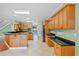Open kitchen with center island, granite countertops, stainless steel appliances, and light green wall paint at 17631 Vista Belle Ct, Montverde, FL 34756