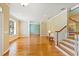 Bright living room with hardwood floors, staircase, and a view to the dining room at 17631 Vista Belle Ct, Montverde, FL 34756