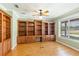 Charming home office with custom built-in shelving and a large window providing natural light at 17631 Vista Belle Ct, Montverde, FL 34756