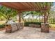 Outdoor kitchen boasts a built-in grill, stainless steel appliances, and stone accents at 17631 Vista Belle Ct, Montverde, FL 34756