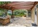 Outdoor kitchen featuring stone accents and a pergola at 17631 Vista Belle Ct, Montverde, FL 34756