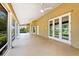 Large covered patio features tile flooring, white columns, and multiple ceiling fans at 17631 Vista Belle Ct, Montverde, FL 34756