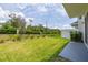 Backyard with a green lawn and a white fence at 1915 Terrapin Rd, Ocoee, FL 34761