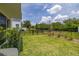 A home's backyard featuring a well-maintained lawn enclosed by a black metal fence, offering a secure outdoor space at 1915 Terrapin Rd, Ocoee, FL 34761